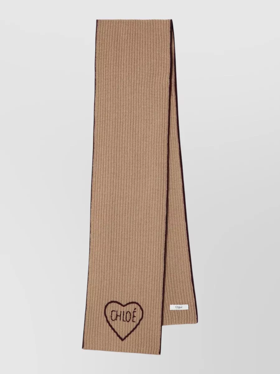Chloé Cashmere wool scarf — The camel ribbed scarf with chocolate piping extends the knit texture story and warm palette around the face, adding soft visual length that harmonizes with the high-rise wide leg.
