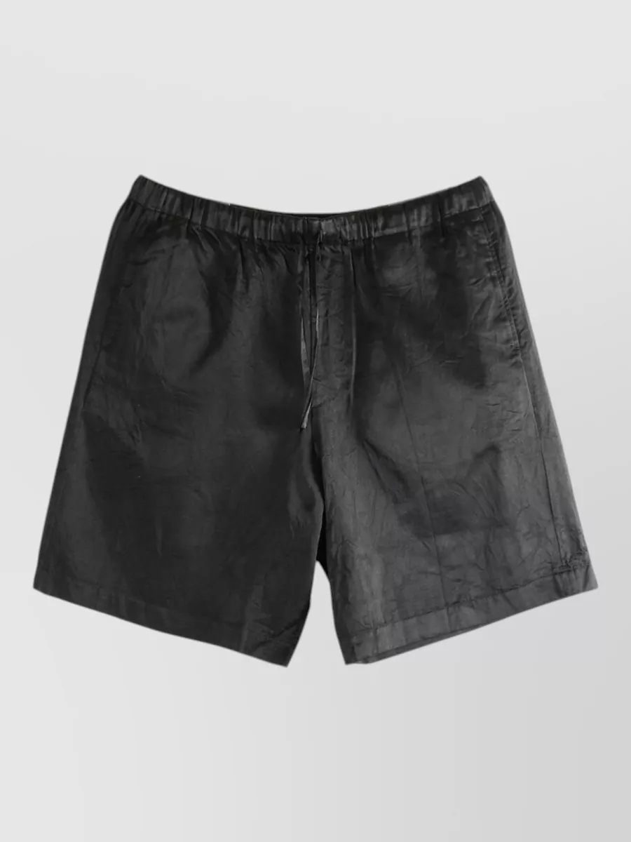 Dries Van Noten Viscose blend drawstring tailored shorts — The clean black tailored short reins in the shirt’s turquoise-and-burgundy print, keeps the focus on the torso, and matches the relaxed yet polished summer mood.