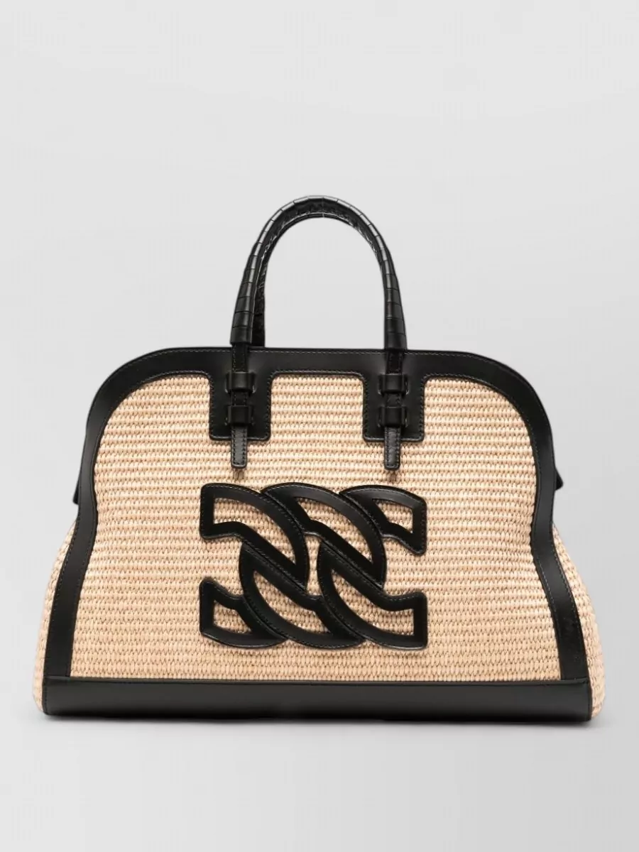 Casadei Leather logo appliqué tote bag — The Casadei raffia and black structured tote ties into the sandals’ black tone while adding a quiet resort texture that keeps the outfit firmly in relaxed, polished beach-to-city territory.