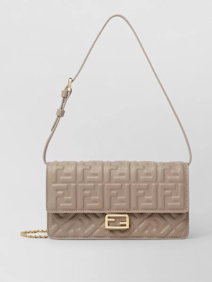 Fendi baguette leather shoulder bag — The Fendi taupe structured flap bag sits in the same neutral family, matches the quiet-luxury tier, and adds a compact, city-ready finish that suits the outfit’s smart polish.