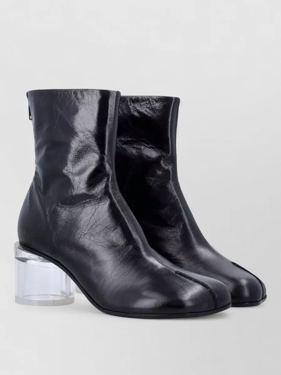 Mm6 Maison Margiela Leather ankle boots — The Alexander Wang mesh stilettos reinforce the sheer, graphic theme and y2k edge, giving the tailored trouser and tee combination a precise, after-dark polish.