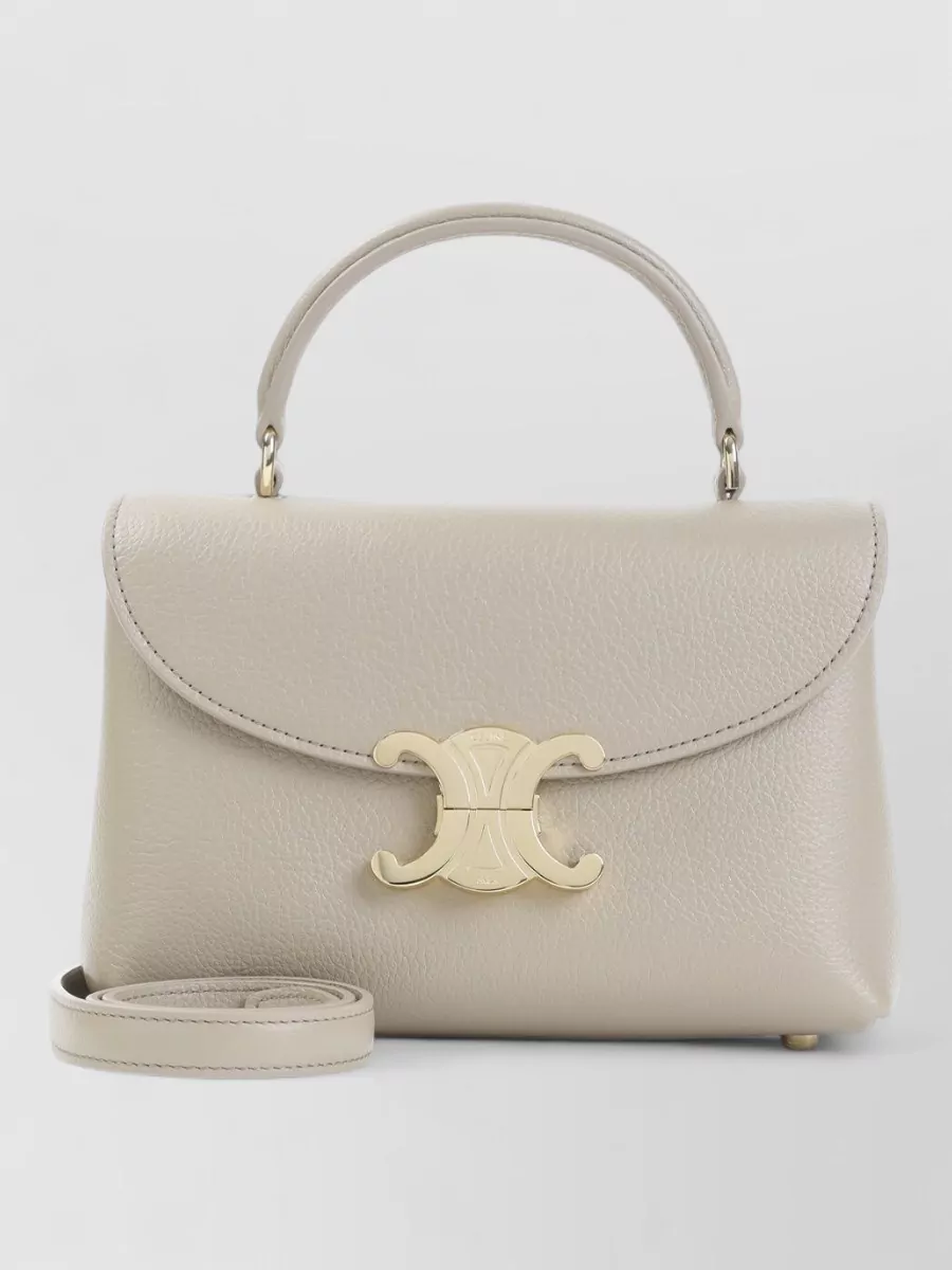 Celine Leather mini shoulder bag — Celine’s warm taupe mini top-handle is the right scale for an evening mini, its gold hardware mirrors the dress buttons, and the neutral tone bridges grey tweed and brown boots effortlessly.