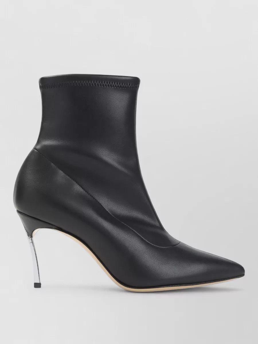 Casadei Leather pointed-toe stiletto ankle boots — The Casadei ankle-height pump has a razor pointed toe and metal stiletto that echo the blazer’s sharp tailoring and the trouser’s column shape, ideal for dressy work-to-dinner dressing.