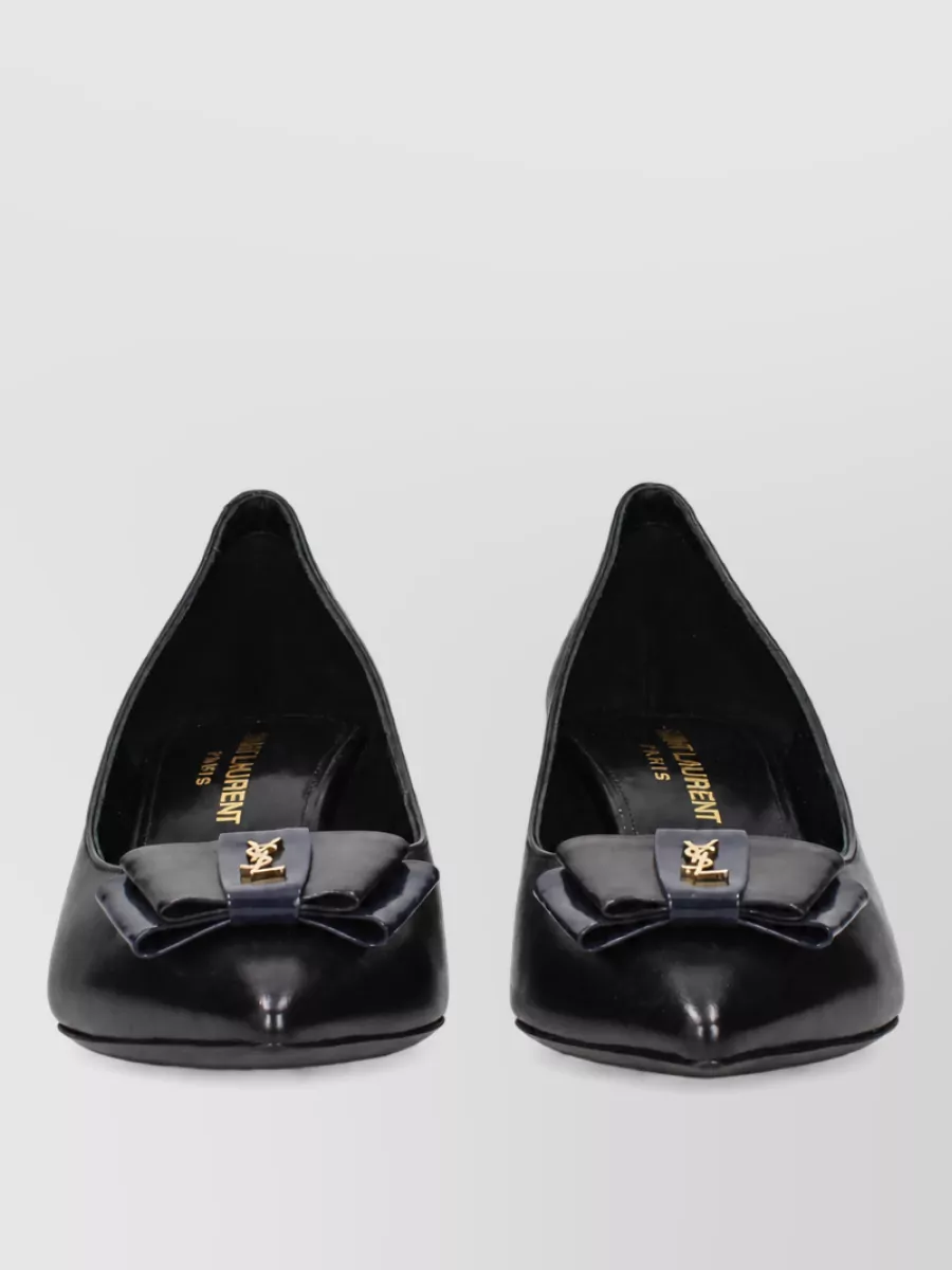 Saint Laurent Leather ballerina shoes — The pointed low-heel Saint Laurent ballerina delivers refined evening-leaning polish with subtle gold detail, echoing the trouser’s tailored ease and keeping the outfit walkable yet distinctly dressy.