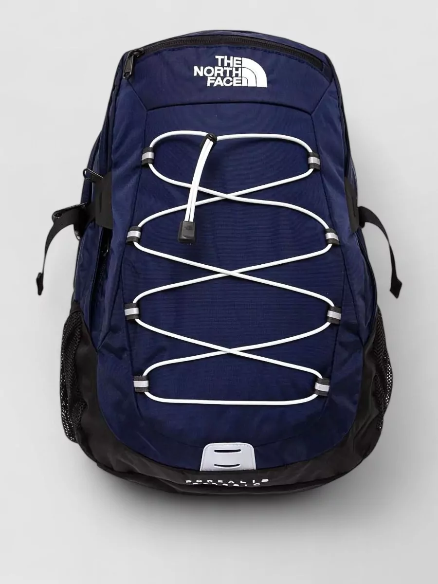 The North Face Borealis classic backpack — Backpack A in navy, black and white ties directly into the jacket’s color and brand, reinforcing a cohesive commuter-to-trail kit in both function and palette.