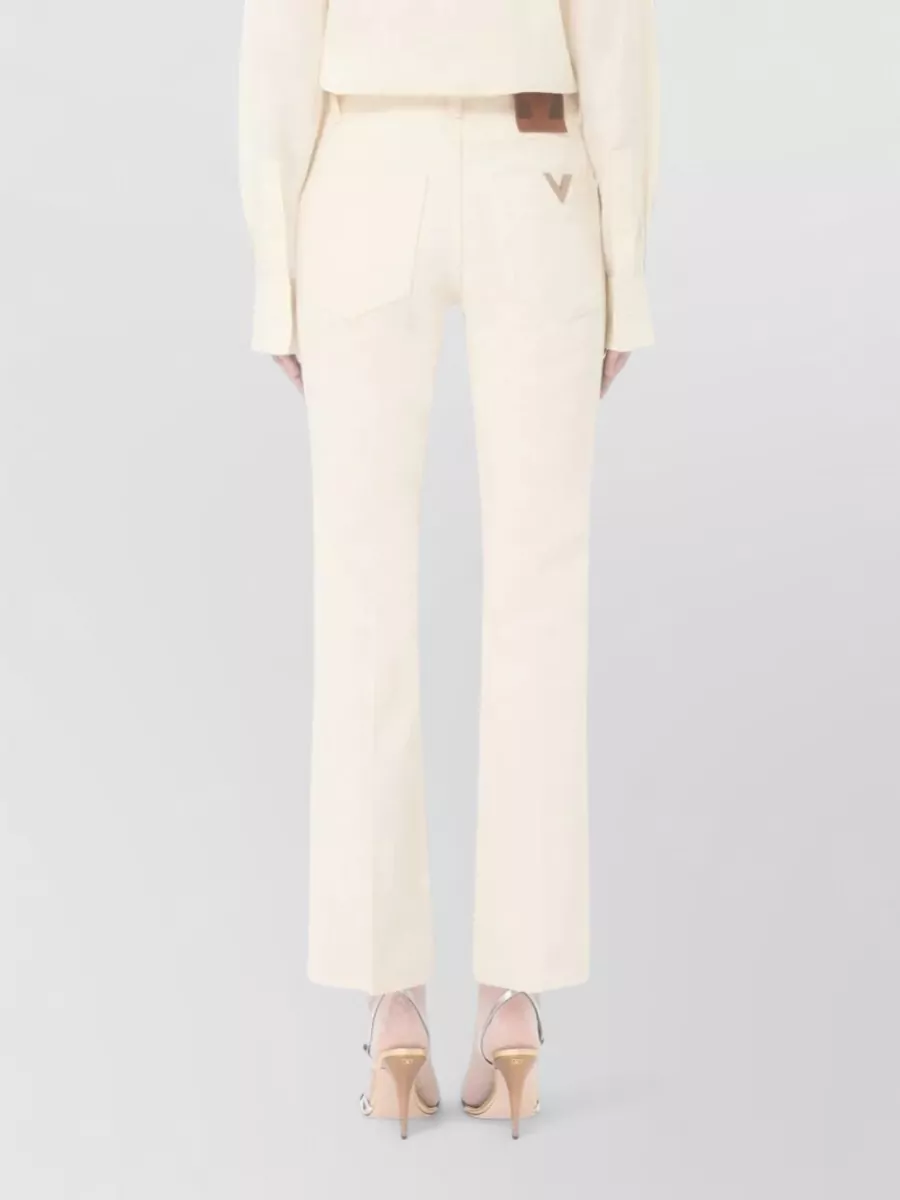 Valentino Garavani Flared Denim Trousers Featuring Pockets And Loops