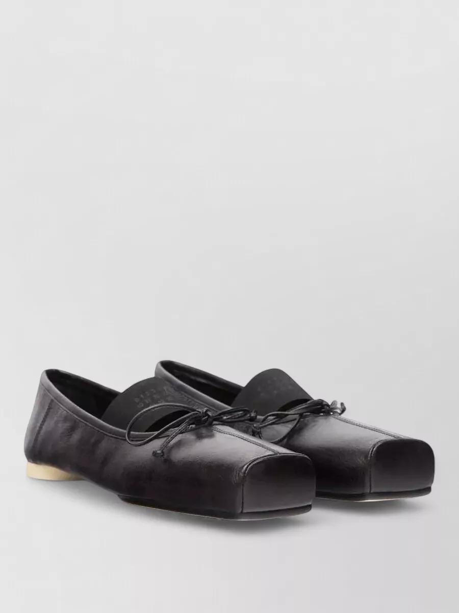 Mm6 Maison Margiela Leather knot ballerina shoes — The black Tabi ballerina directly echoes the split-toe of the socks, aligns in formality, and keeps the head-to-toe Margiela story tight and understated.