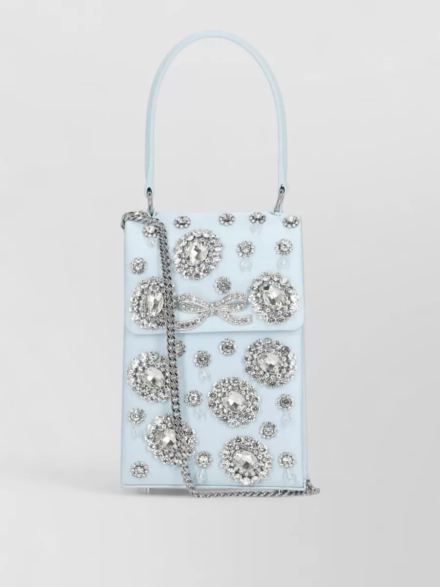 Self-Portrait the bow mini crystal-embellished satin shoulder bag — The ice-blue Self-Portrait mini top-handle perfectly matches the palette and romantic crystal detailing of the dress and shoes, creating a polished, tonal occasion ensemble.