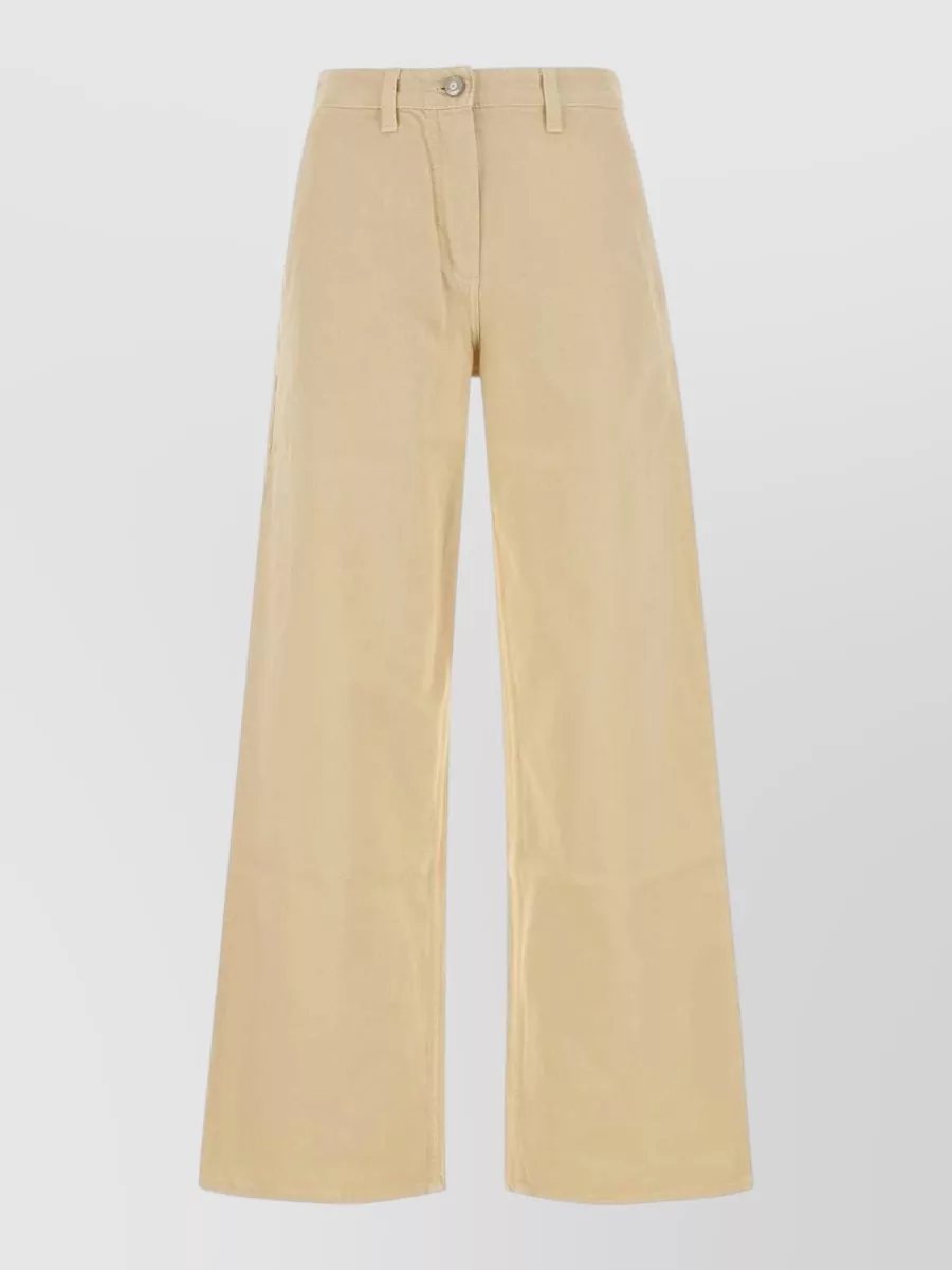Magda Butrym Denim wide-leg trousers — The Magda Butrym high-rise light beige wide-leg trouser keeps the mood minimalist and polished, echoing the bag’s warm neutral tone and balancing the boxy top with a long, fluid leg.