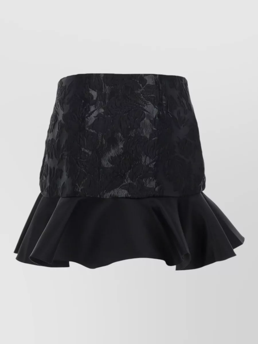 Ganni Satin mini skirt — The black glossy brocade mini keeps the focus on the metallic animal blazer while matching its sheen and formality, creating a sharp, leggy night-out proportion without clashing prints.