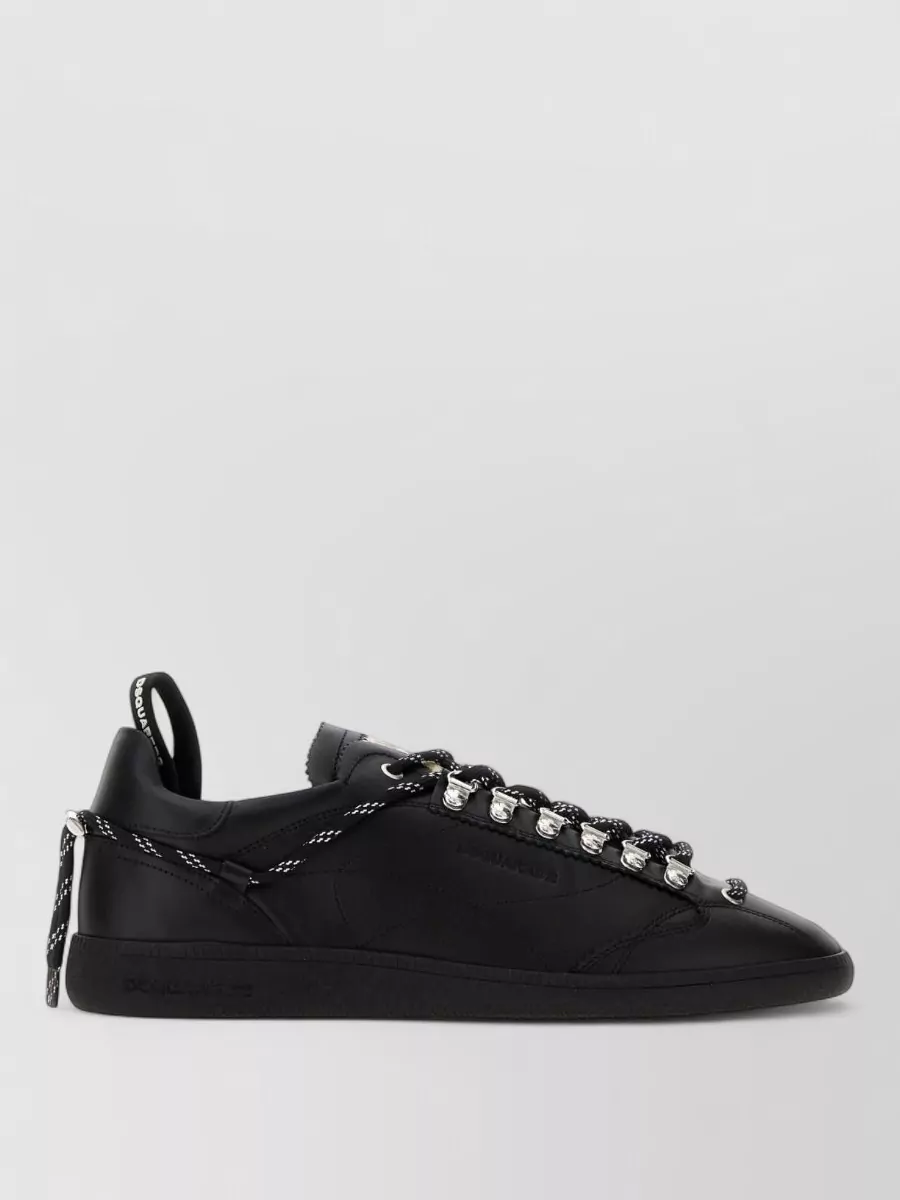 Dsquared2 Leather lace-up sneakers — The black leather low-top with trekking laces is graphic yet pared back, echoing the tee’s minimal branding while grounding the washed black denim in a cohesive, all-black streetwear story.