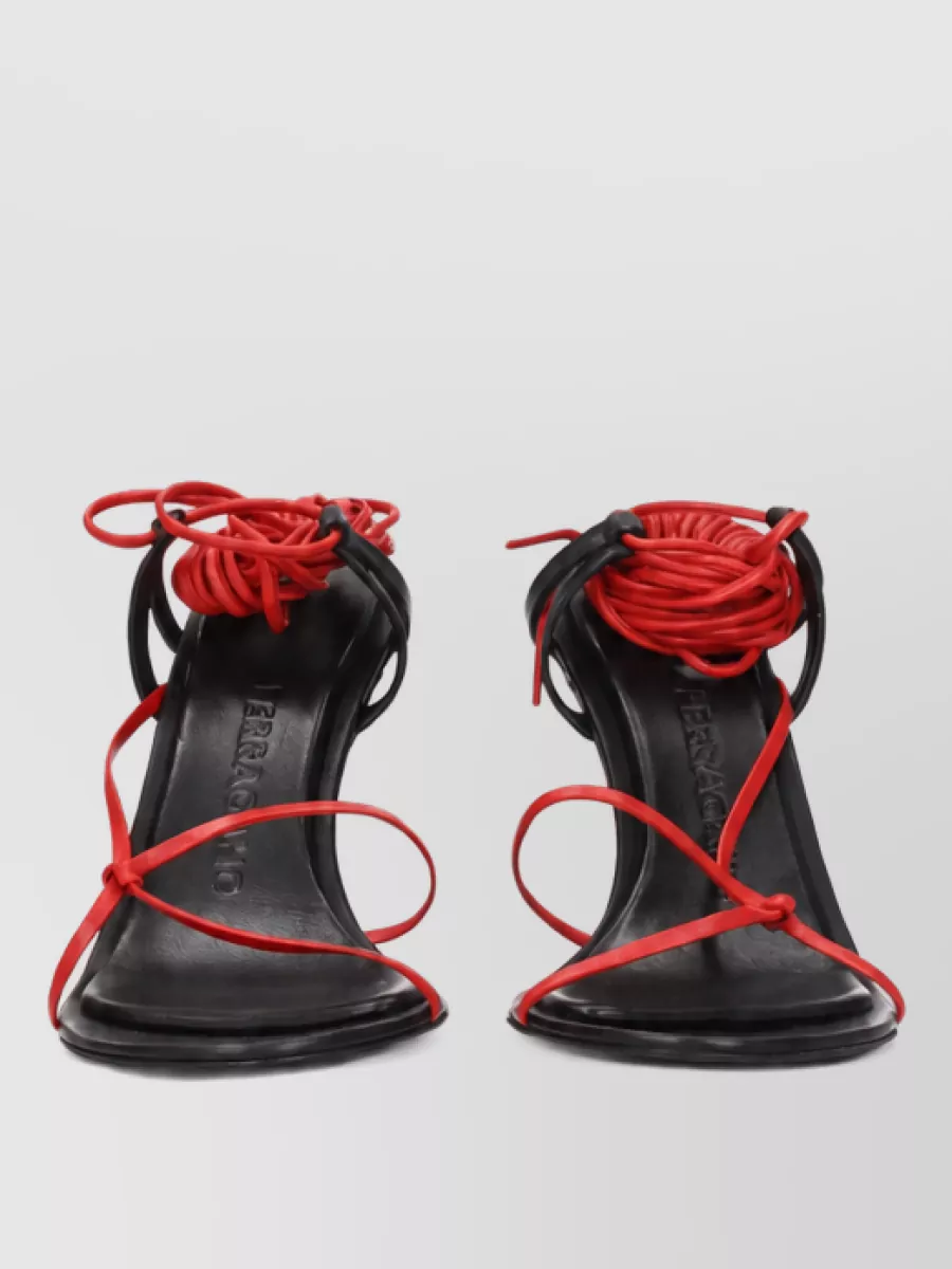 Ferragamo Leather sandals — The Attico’s glossy black block-heel mules echo the top’s attitude and keep the palette graphic, while the square toe and sturdy heel feel modern and club-ready with slim leggings.