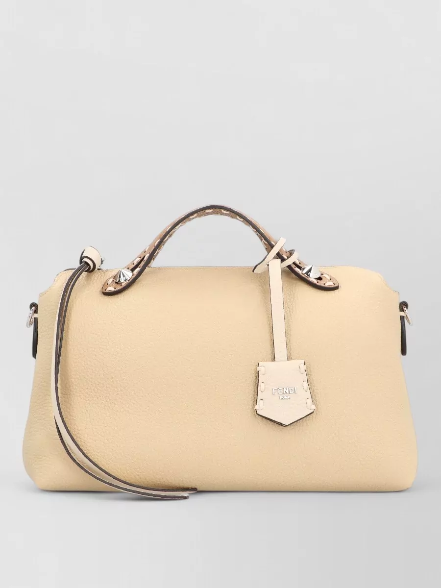 Fendi by the way leather shoulder bag — The butter-beige Fendi satchel stays within the same quiet-neutral palette as the boots and dress, keeping the mood minimalist and polished without adding dark contrast.