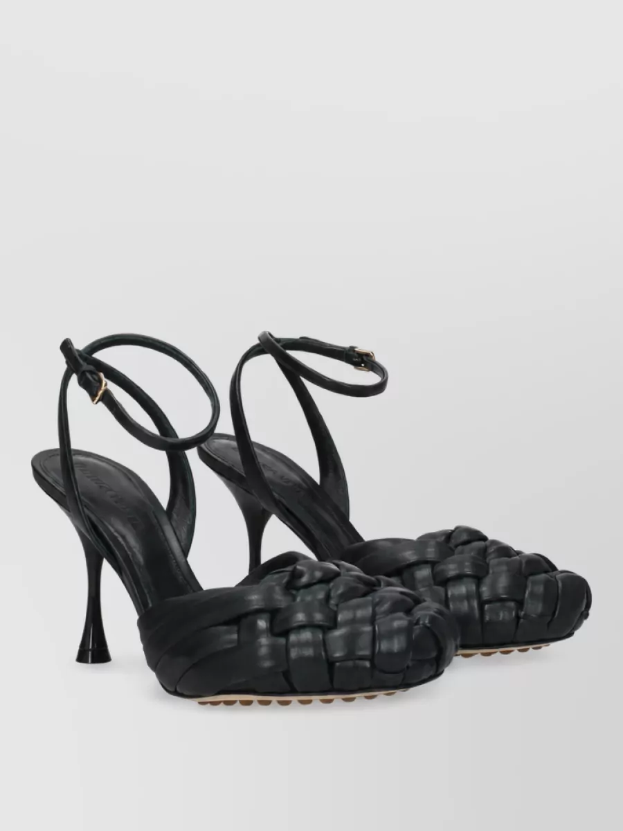 Bottega Veneta Leather sandals — The black woven stiletto sandals are evening-appropriate, visually light with the slim dress, and echo Bottega’s sculptural codes while keeping the palette deep and clean.