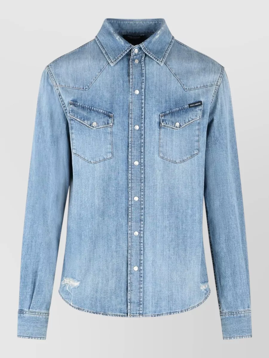 Dolce&Gabbana Denim long-sleeve shirt — The light-wash Western shirt in B hits the brief for relaxed SS denim-on-denim, giving a soft tonal contrast against the dark indigo jean while matching its streetwear-tailored energy.