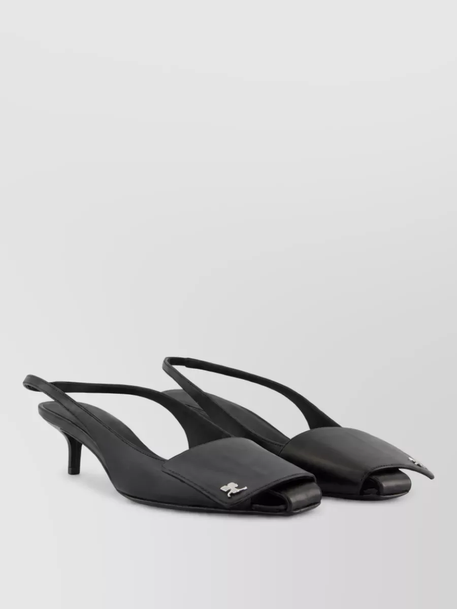 Courrèges Leather slingback mules — The black slingback kitten mules feel sleek and modern, giving just enough height to extend the flared knit’s leggy line while staying light and summery.