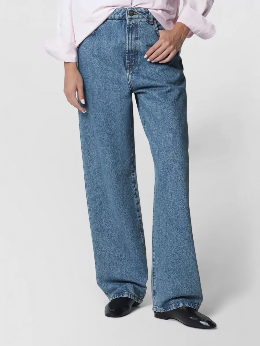 Róhe Denim jeans — The mid-blue wide-leg denim matches the jacket’s suggested styling, balances its boxy cropped volume, and keeps the outfit modern and relaxed within the same brand language.
