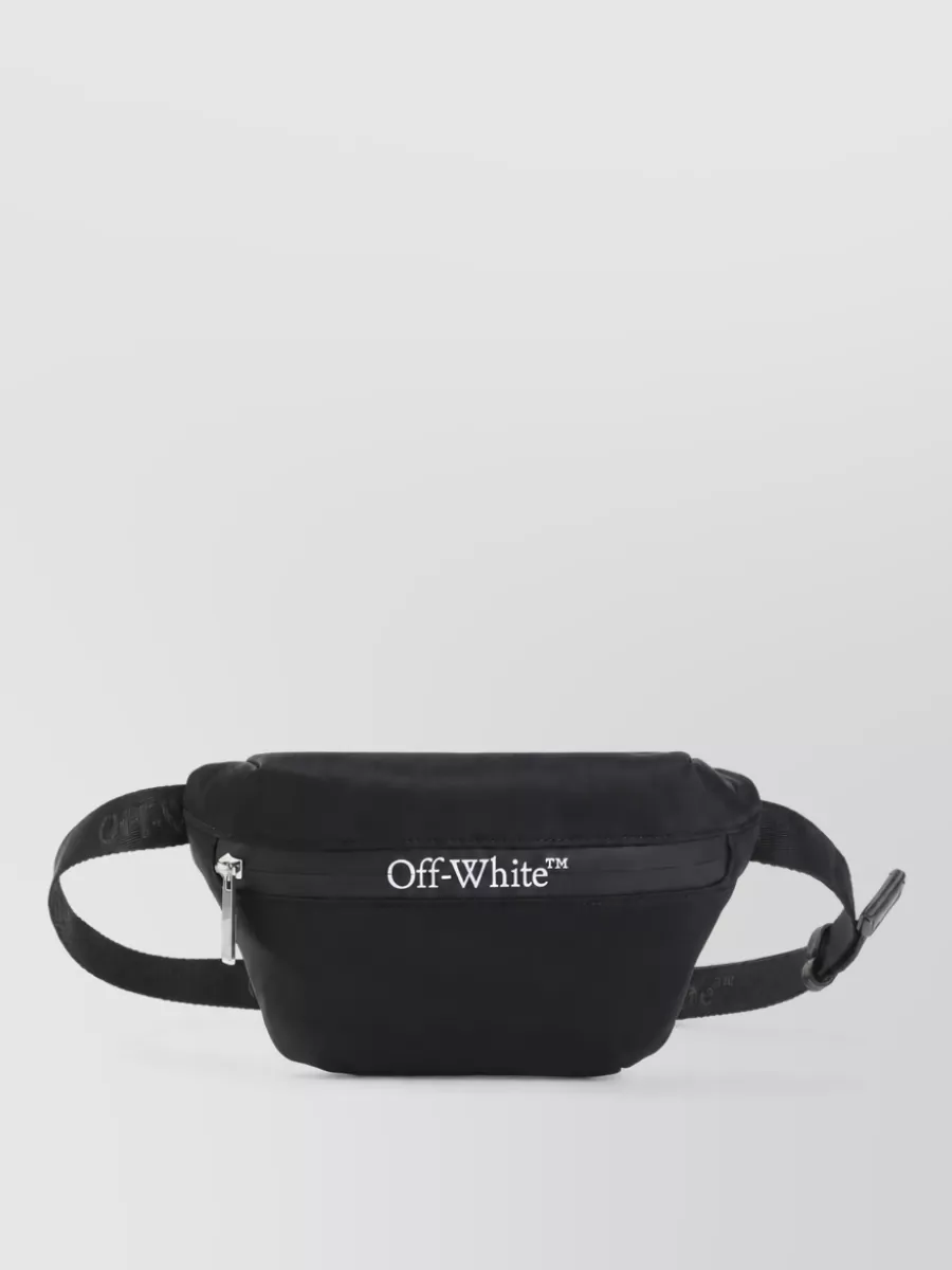 Off-White Nylon belt bag — The Homme Plissé pleated belt bag keeps the line close to the body, matching the minimal monochrome palette and adding a subtle architectural texture that suits the quietly graphic Entire Studios pieces.