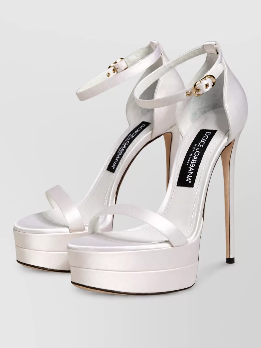 Dolce&Gabbana Leather platform ankle strap sandals — The champagne nude strappy sandals offer a refined metallic sheen and barely-there straps that elongate the leg and complement the ivory gown for modern bridal or evening wear.