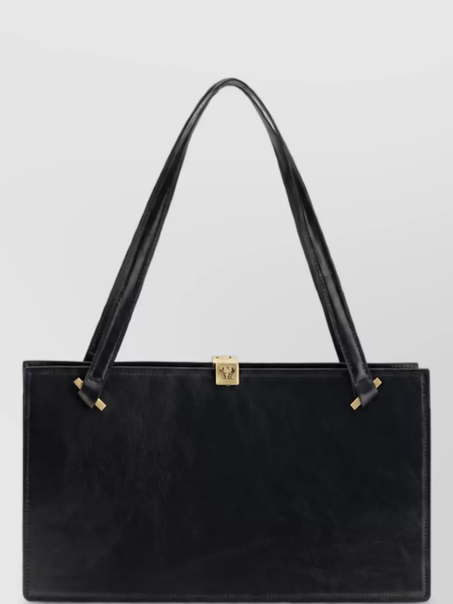 Versace Na calf leather shoulder bag — Bag B’s structured black top-handle with discreet gold Medusa is polished and architectural, mirroring the trousers’ quiet Versace codes and the pumps’ gold accents.