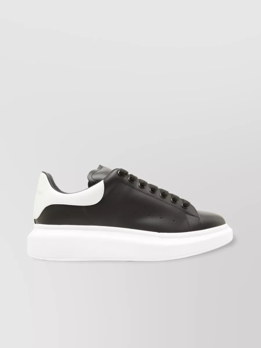 Shop Alexander Mcqueen Oversized Perforated Leather Sneakers In Black