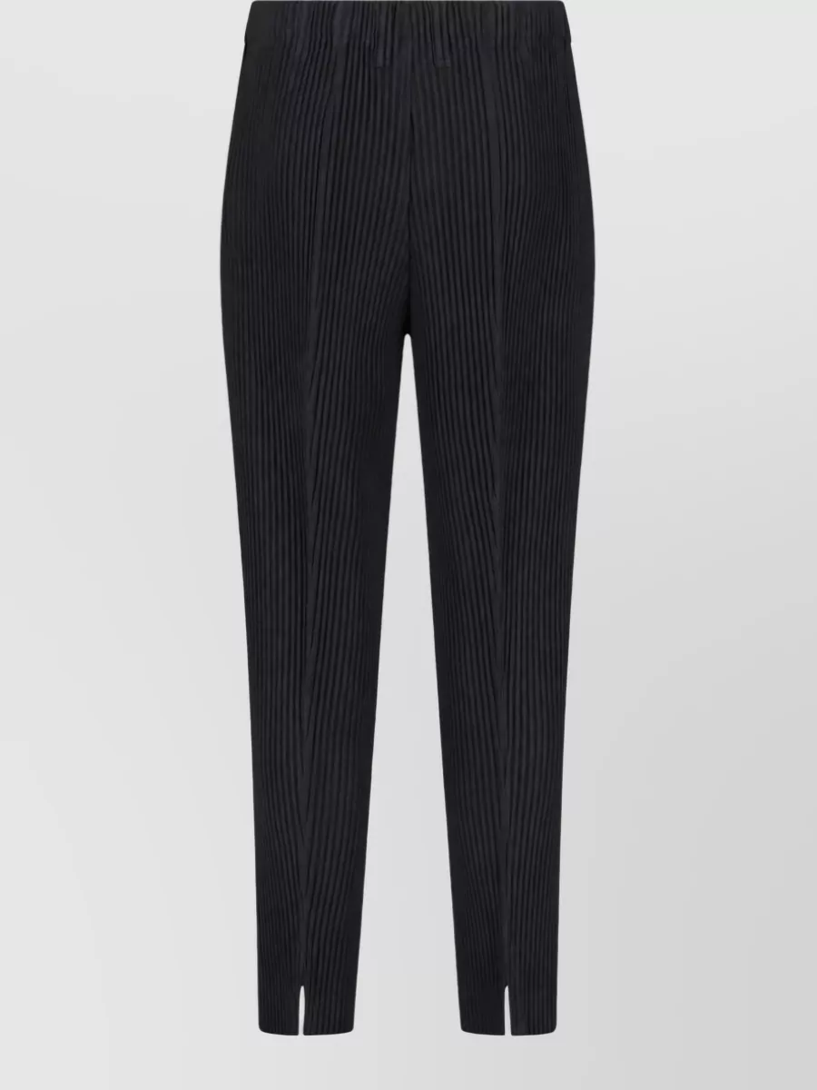 Homme Plisse Issey Miyake Tailored pleats 1 straight-leg trousers — The tapered pleated trouser with ankle slits mirrors the blazer’s vertical ribs and formality, giving a sharp, modern line that feels suited to evening and elevated daywear.