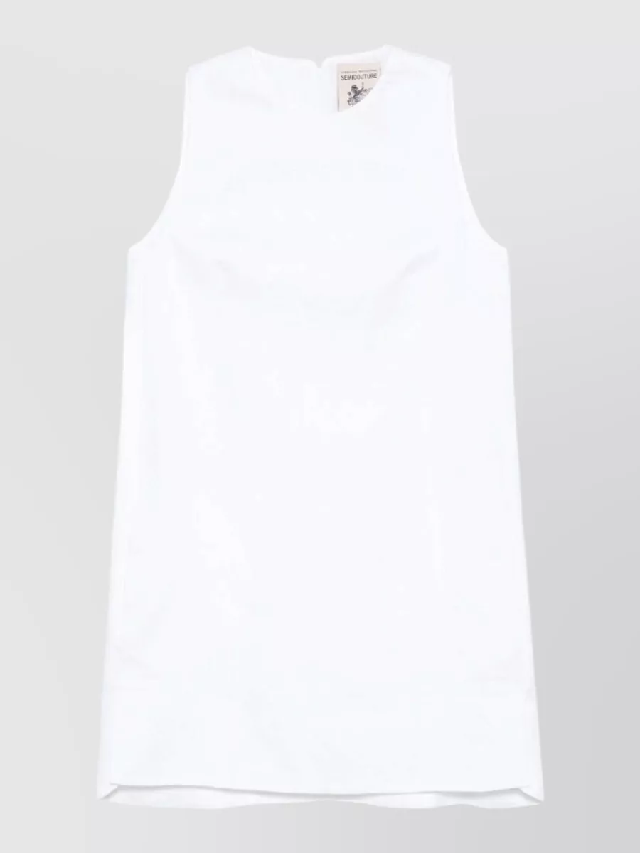 Semicouture Linen sleeveless mini dress — The crisp white sleeveless shell keeps the suede midi skirt light and modern, echoing its clean minimalism while giving a fresh contrast that works for warm-weather quiet luxury.