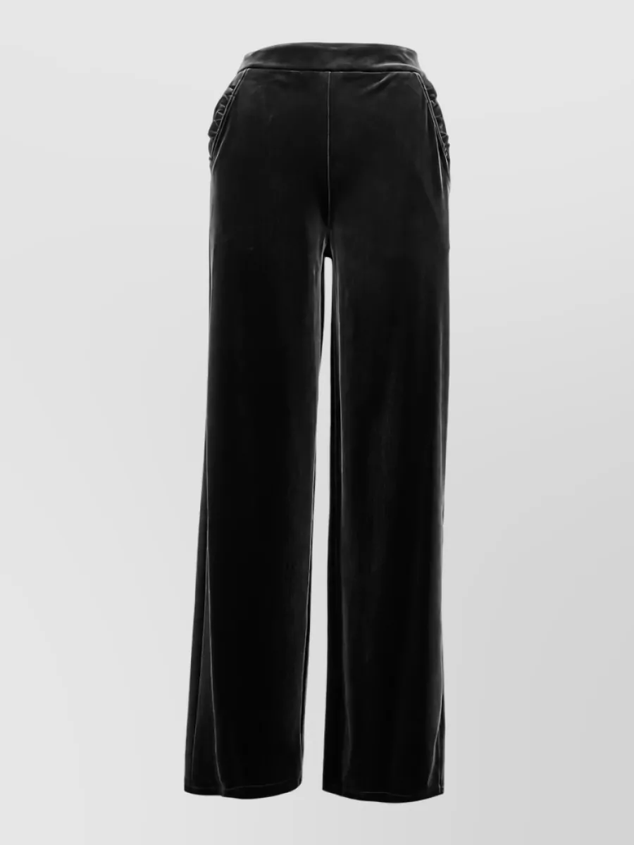 Emporio Armani Velvet wide-leg trousers — The high-waisted black wide-leg trouser creates a long, fluid line that balances the bomber’s cropped volume and leans into an evening-ready, quiet-luxury mood.