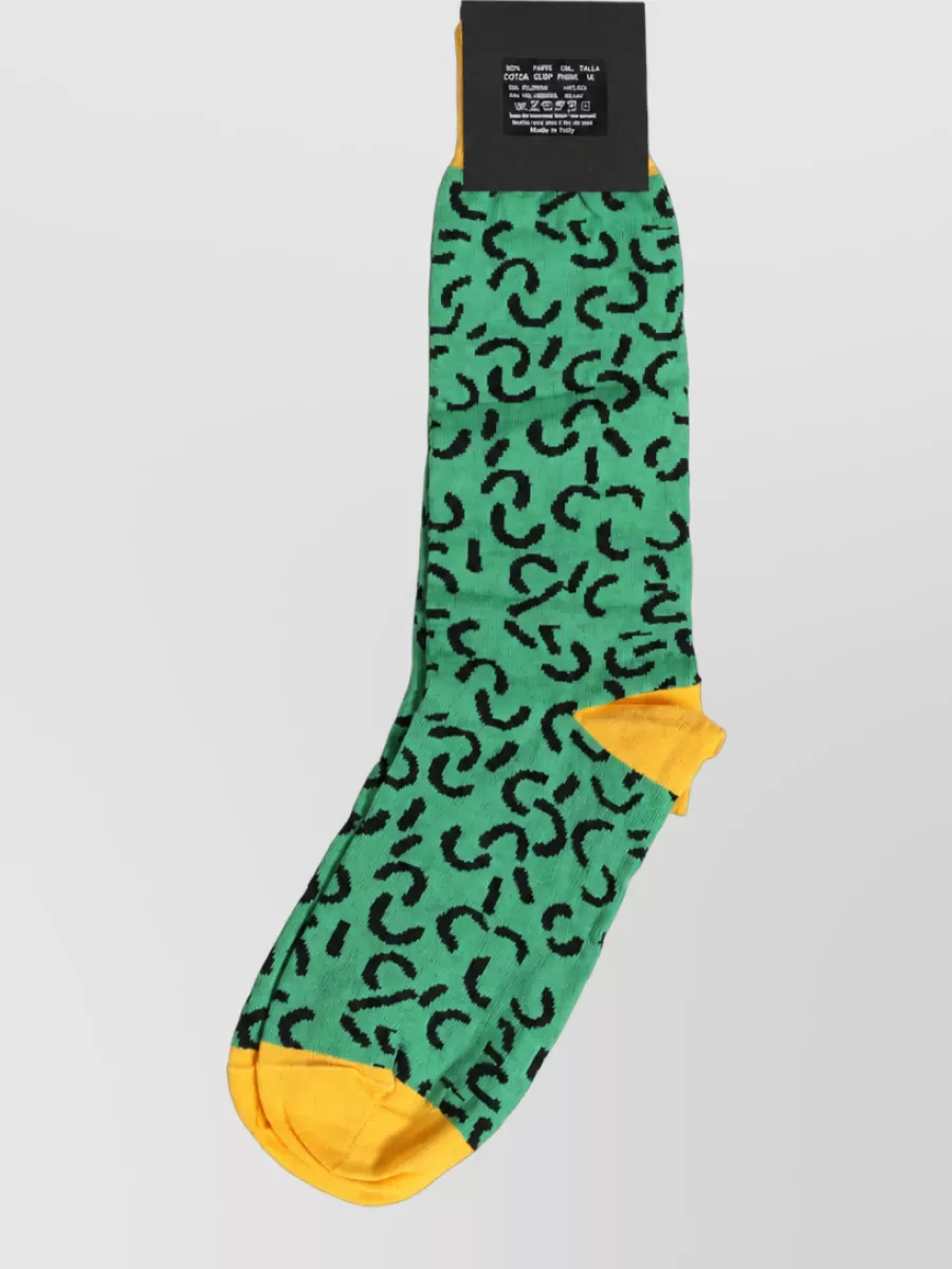 Dolce&Gabbana Abstract mid calf socks — The vibrant green and mustard socks subtly pick up the hoodie’s acid greens and yellows, giving a deliberate flash of color between trouser hem and sneaker without overwhelming the outfit.