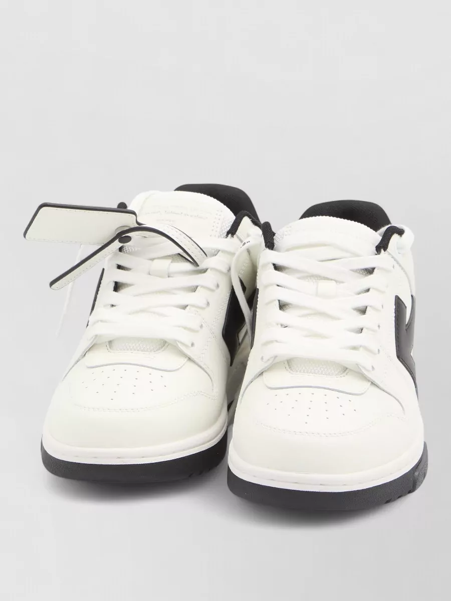 Off-White Leather low-top sneakers — The white-and-black low-top sneakers mirror the hoodie’s off-white body and black trim perfectly, keeping the footwear crisp, graphic and on-brand without adding extra colour.