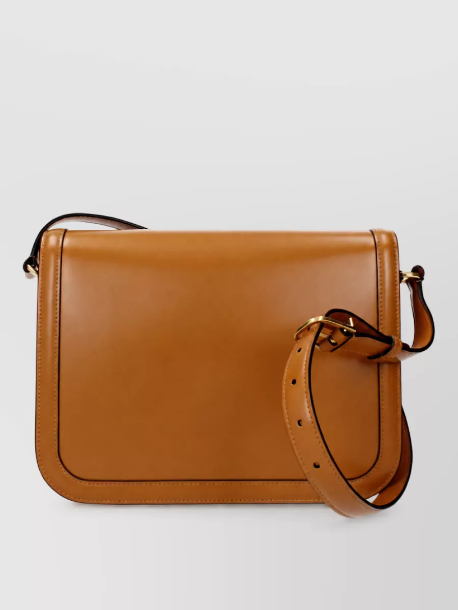 Valentino Garavani Leather crossbody bag — The caramel Valentino crossbody introduces a single warm leather note that ties in with the belt and loafer soles, staying minimalist and structured without overpowering the neutral ensemble.