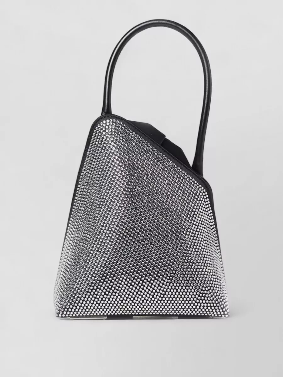 The Attico Leather bucket bag — The deep berry Stella bag matches the dress’s color and studded texture, tying the palette together while its silver chain hardware talks perfectly to the dress detailing and boot hardware.