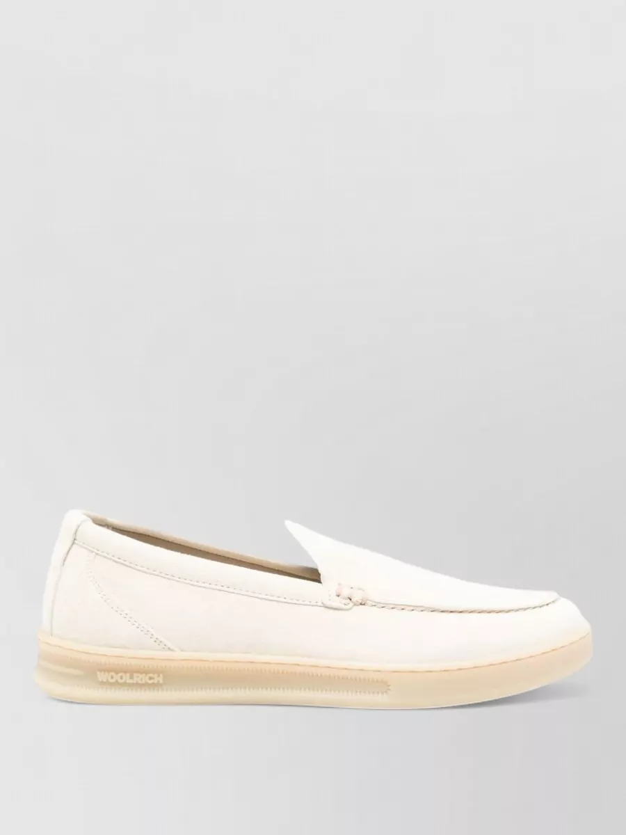 Woolrich Leather slip-on sneakers — The Carel cream and black slingback ballerina nails that Left Bank, low-heel polish, aligning perfectly with the cardigan’s preppy minimalism and the tailored wide-leg trouser.