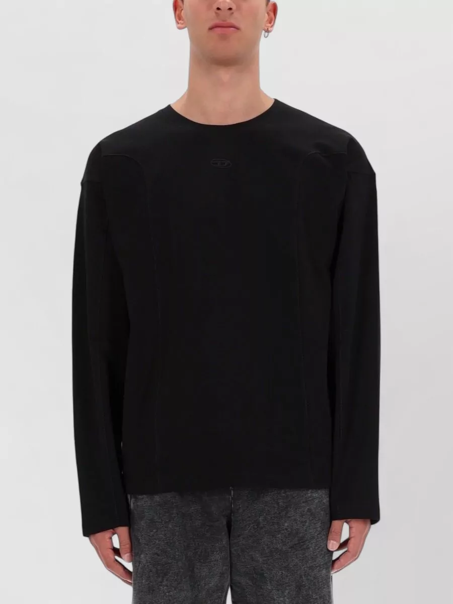 Diesel Cotton t-shirt — The black crew with washed charcoal panels mirrors the jacket’s distressed seams, keeping the upper half tonal and streamlined without competing with the outerwear.