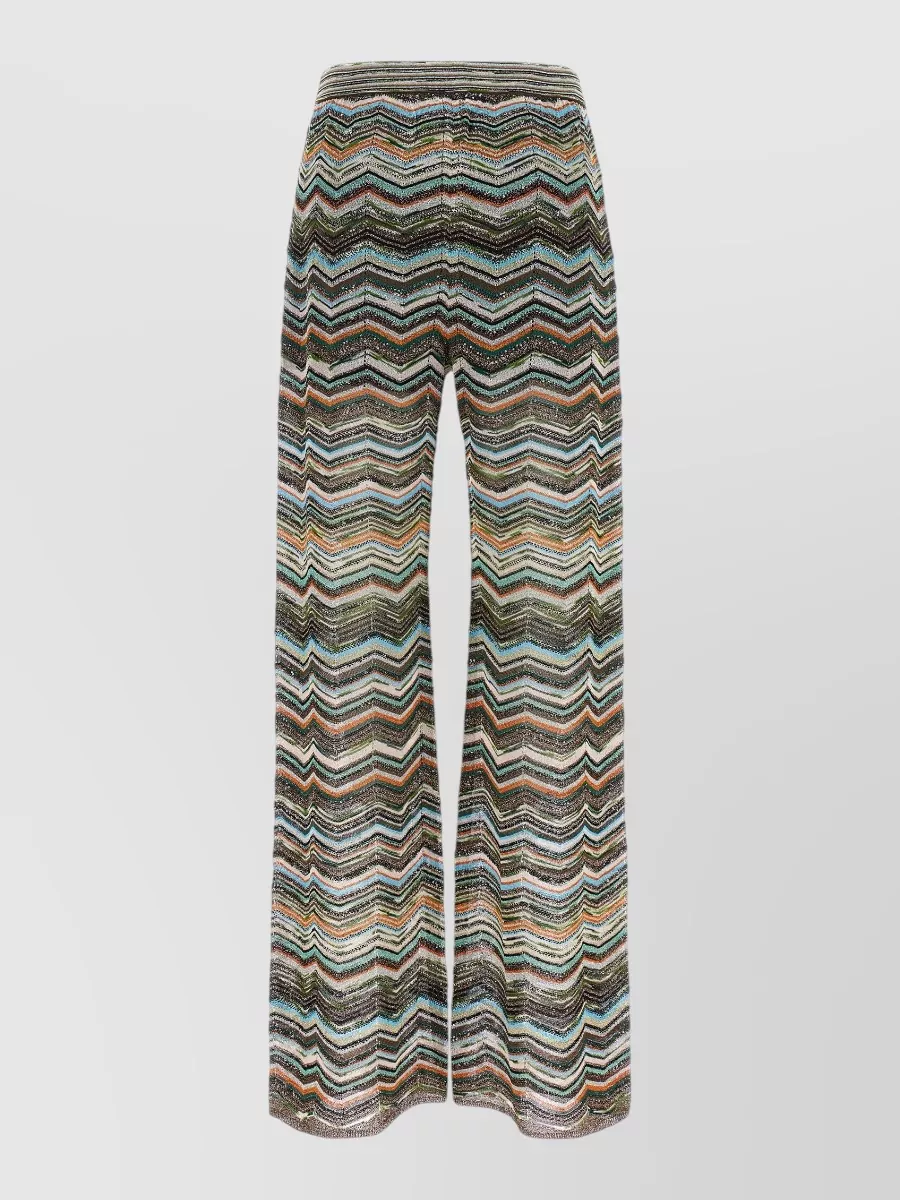 Missoni Zigzag sequin high-rise wide-leg trousers — The relaxed zigzag knit in forest green, soft apricot and sea blue echoes the body’s apricot and seafoam tones without competing, keeping the y2k‑boho story soft and resorty rather than over-formal.