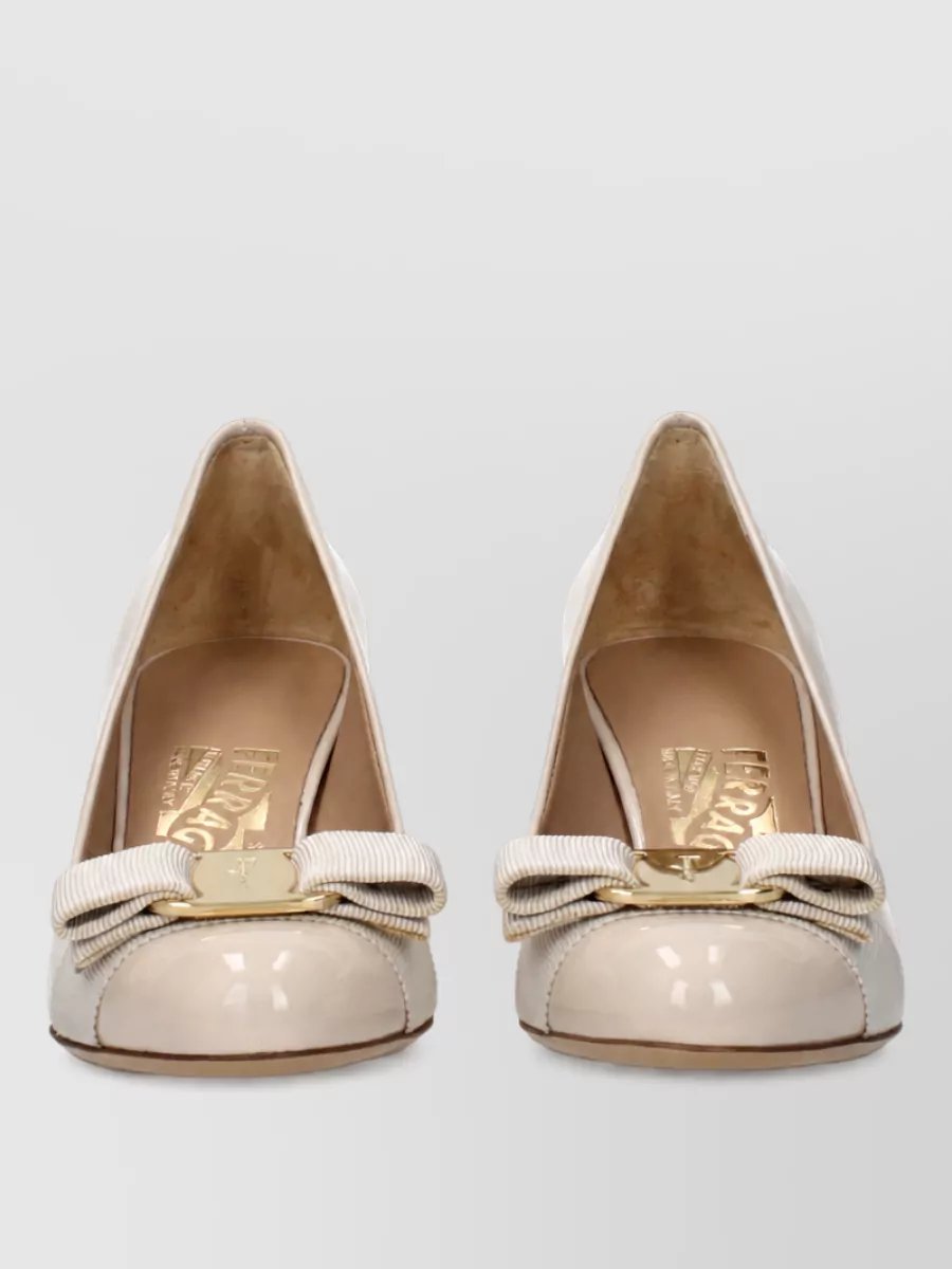 Ferragamo Patent leather ballerina shoes — The Ferragamo cream patent ballerinas echo the dress’s butter-yellow trim and preppy polish, keeping the 60s-inspired mini feeling refined and desk-to-dinner appropriate without adding heaviness.