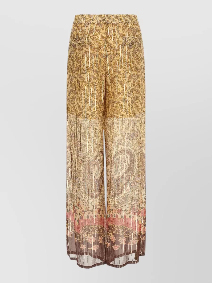 Valentino Garavani Silk wide-leg trousers — The cream-and-black high-waisted maxi skirt in E quietly anchors the blouse’s busy paisley while echoing its cream ground and formal, romantic-tailored mood for an elegant evening silhouette.