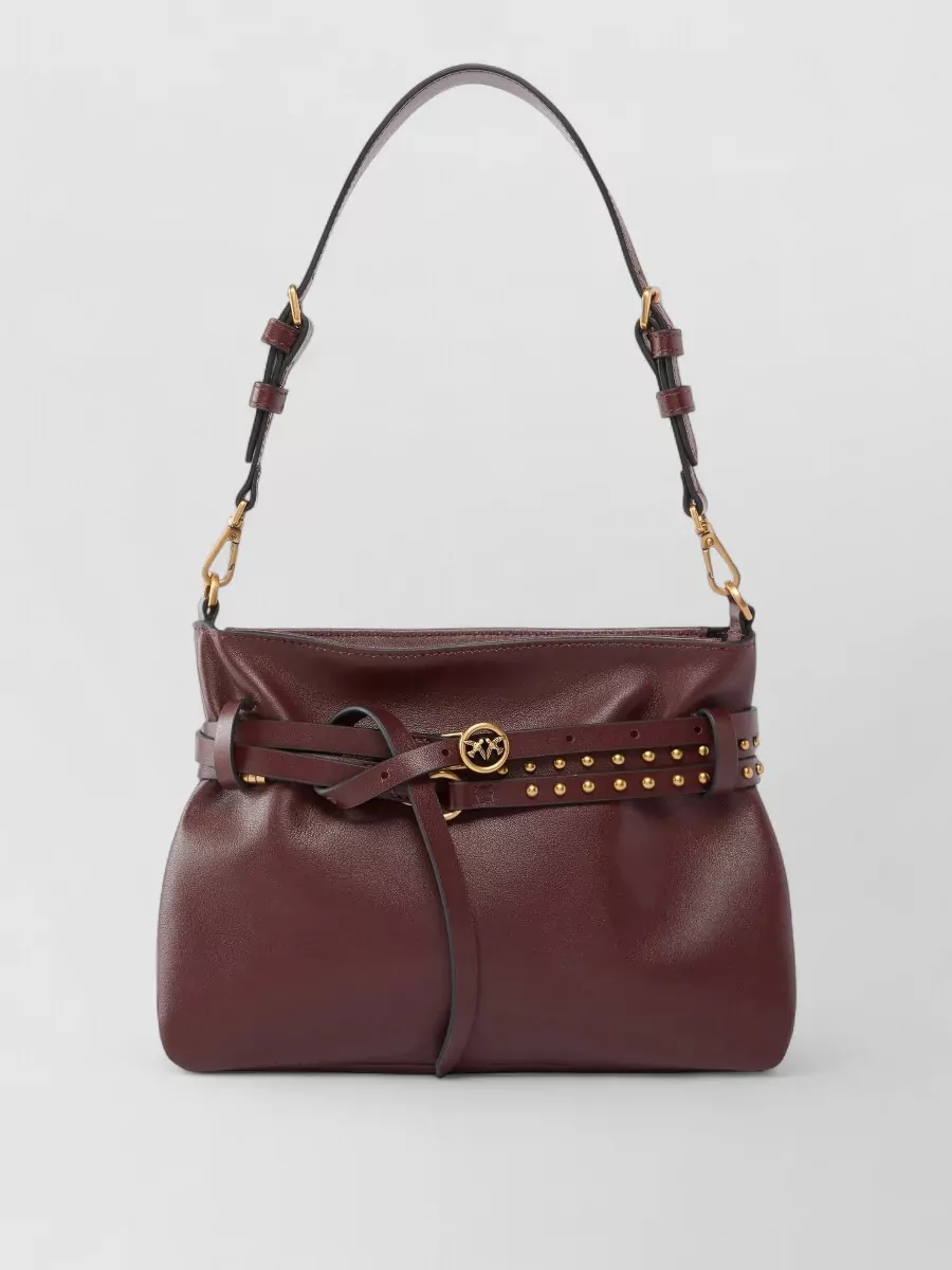 Pinko Leather shoulder bag — The Yuzefi oxblood bucket echoes the wine tones of the trouser and heel while its sculpted but clean shape reinforces the minimalist, high-end tailoring story.