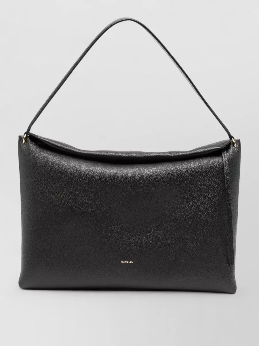 Wandler penelope suede leather tote bag — Wandler’s large black tote delivers a structured, quiet statement that suits the longline vest and tailored trouser, keeping the look boardroom-ready without breaking the minimalist, monochrome palette.