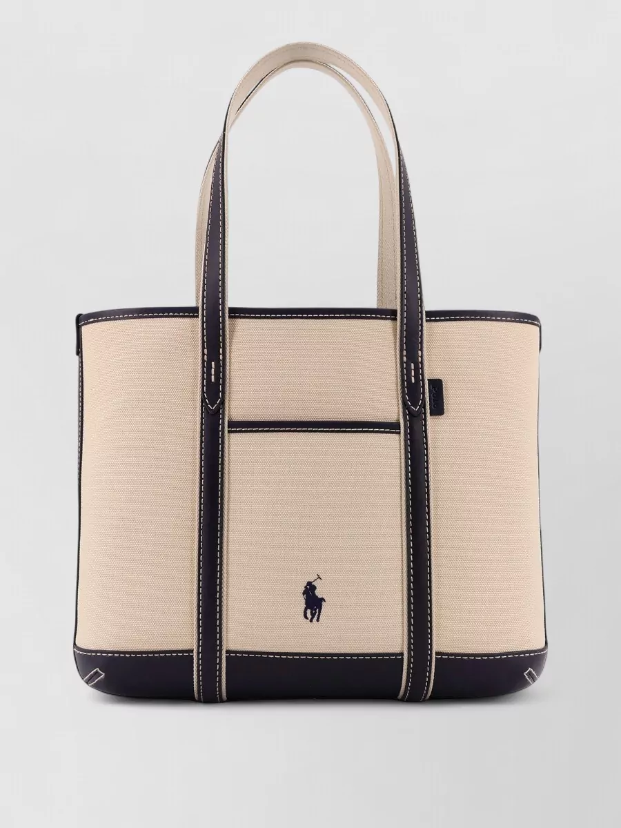 Polo Ralph Lauren Canvas shoulder bag embroidered logo front — The Polo Ralph Lauren canvas tote with navy trim echoes the dress’s palette and coastal energy, staying polished enough for city days while keeping the overall story cohesive.