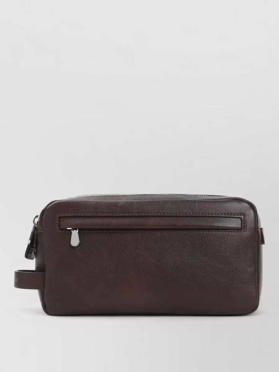 Brunello Cucinelli Leather toiletry bag — A, the slim dark-chocolate Celine crossbody, matches the top’s tone, keeps the line vertical and minimal, and aligns with the quiet luxury mood without competing with the pleated texture.