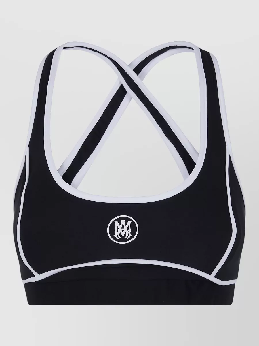 Amiri Amiri active sports bra — The Amiri sports bra mirrors the track pant’s black-and-white striping and logo, creating a clean, cohesive set that leans into a luxe, athletic mood for travel or off-duty days.