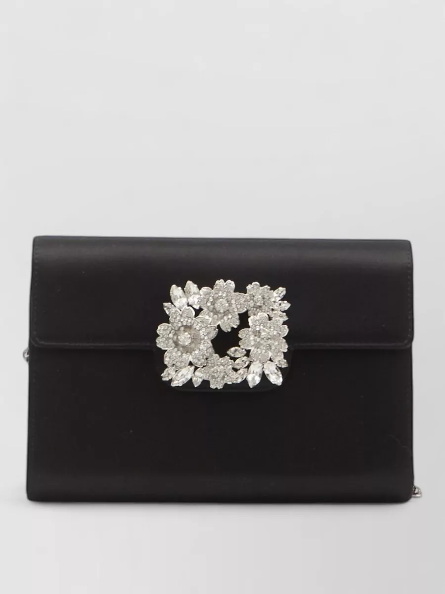 Roger Vivier Satin mini clutch bag — The Roger Vivier black satin clutch with crystal buckle delivers cocktail-level polish and sparkle that harmonises with the gold sandals while letting the red dress remain the statement.