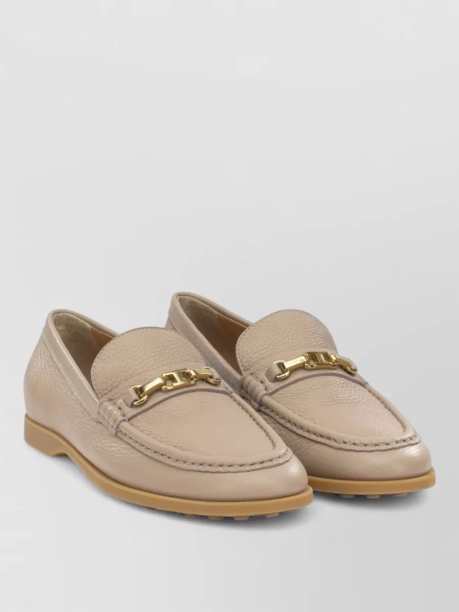 Tod's Leather loafers — The Tod’s beige loafer is preppy, polished and neutral, grounding the knit separates with a structured flat that matches the camel skirt and sits naturally in a quiet luxury wardrobe.