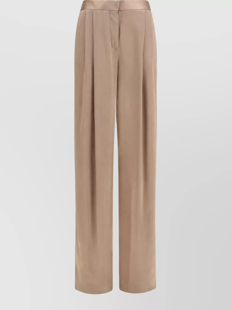 Tom Ford Silk straight-leg trousers — The champagne camel wide-leg trouser keeps the palette soft and tonal with the ivory camisole while adding a long, fluid line that feels quietly luxurious and appropriate for refined evenings.