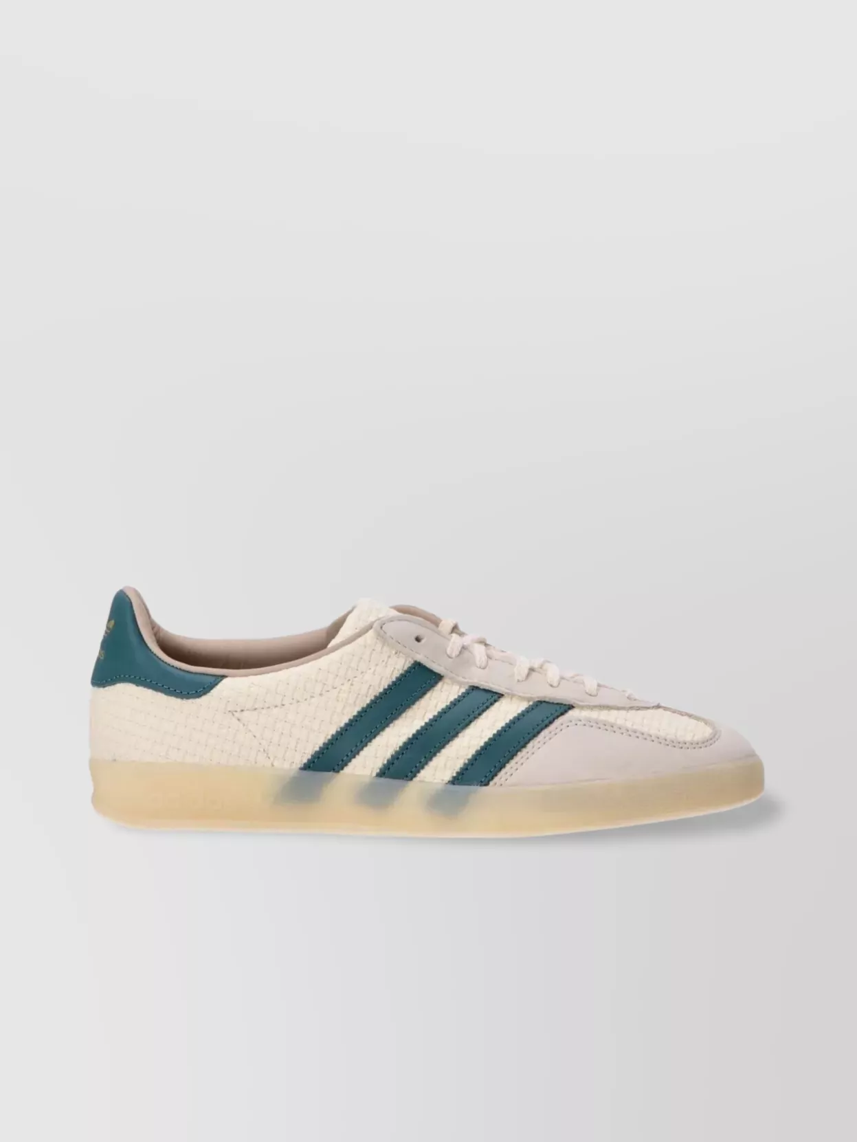 Adidas Suede leather gazelle indoor low-top sneakers — The cream and teal Adidas low-tops feel modern and sporty, tie into the blue story of the sweatshirt and jeans, and keep the whole outfit relaxed but sharp for city wear.