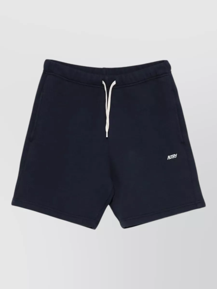 Autry Cotton deck shorts — The navy sweat short in E mirrors the sweatshirt’s colour, branding and sporty minimalism, creating a clean coordinated set that feels right for warm-season off-duty wear.