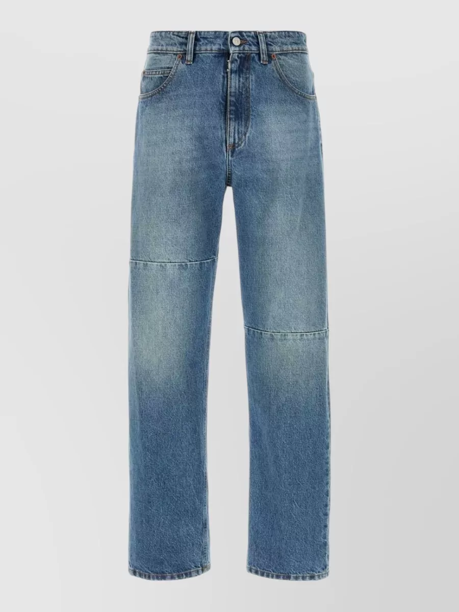 Mm6 Maison Margiela Paneled denim jeans — The Mm6 straight-leg mid blue denim keeps the palette soft and tonal with the washed Moschino tee, adding minimalist structure that matches the tee’s relaxed streetwear mood without clashing logos.
