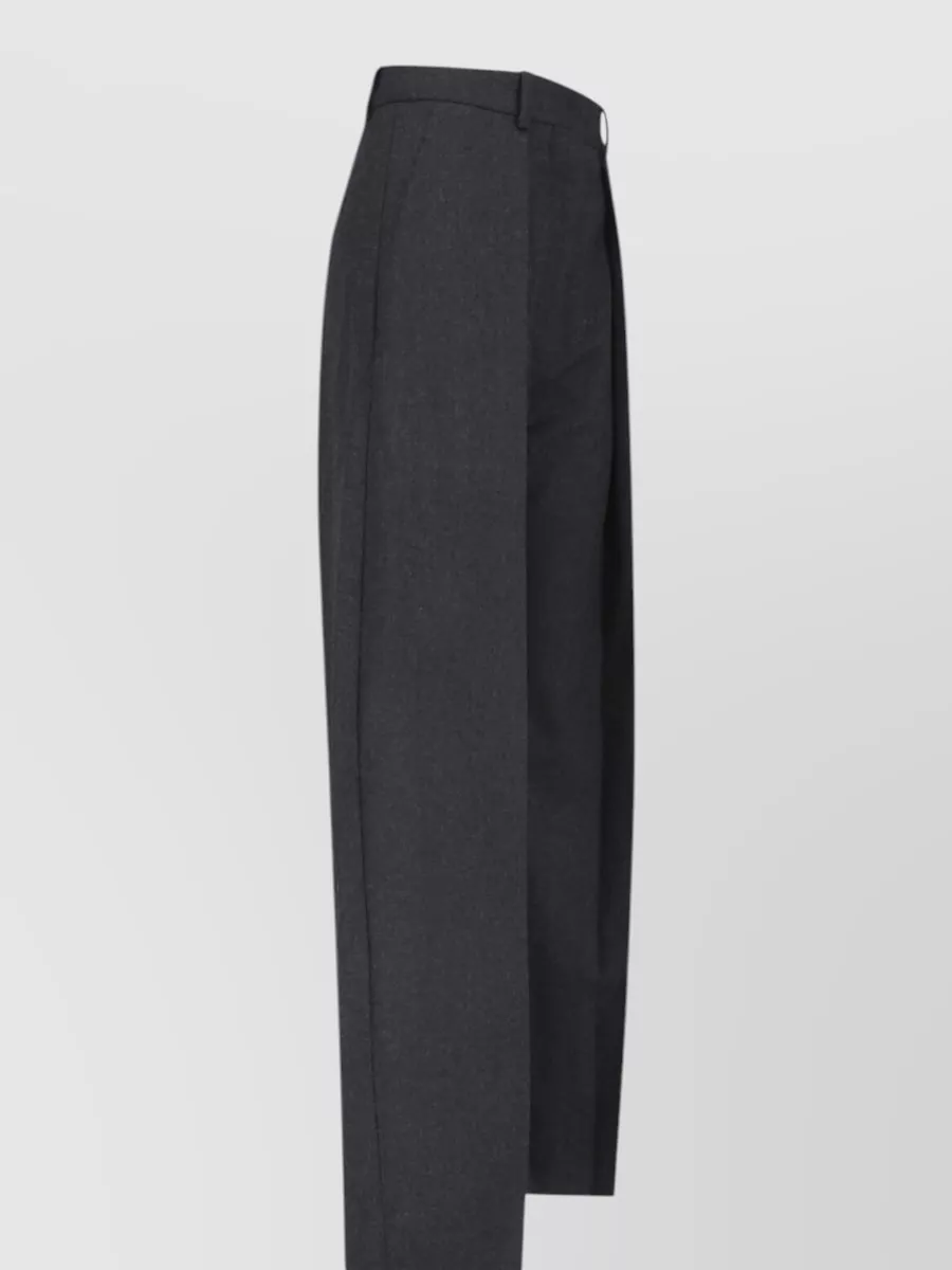 Victoria Beckham Wool straight-leg tailored trousers — The high-rise charcoal tailored trouser mirrors the shirt’s precision and androgynous ease, echoing the suggested styling and keeping the palette refined and modern.