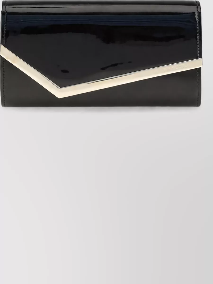 Jimmy Choo Na calf leather clutch bag — The black patent clutch with sharp silver frame feels as polished as the sandals, grounds the rich wine dress, and adds a clean architectural line without competing with the color story.